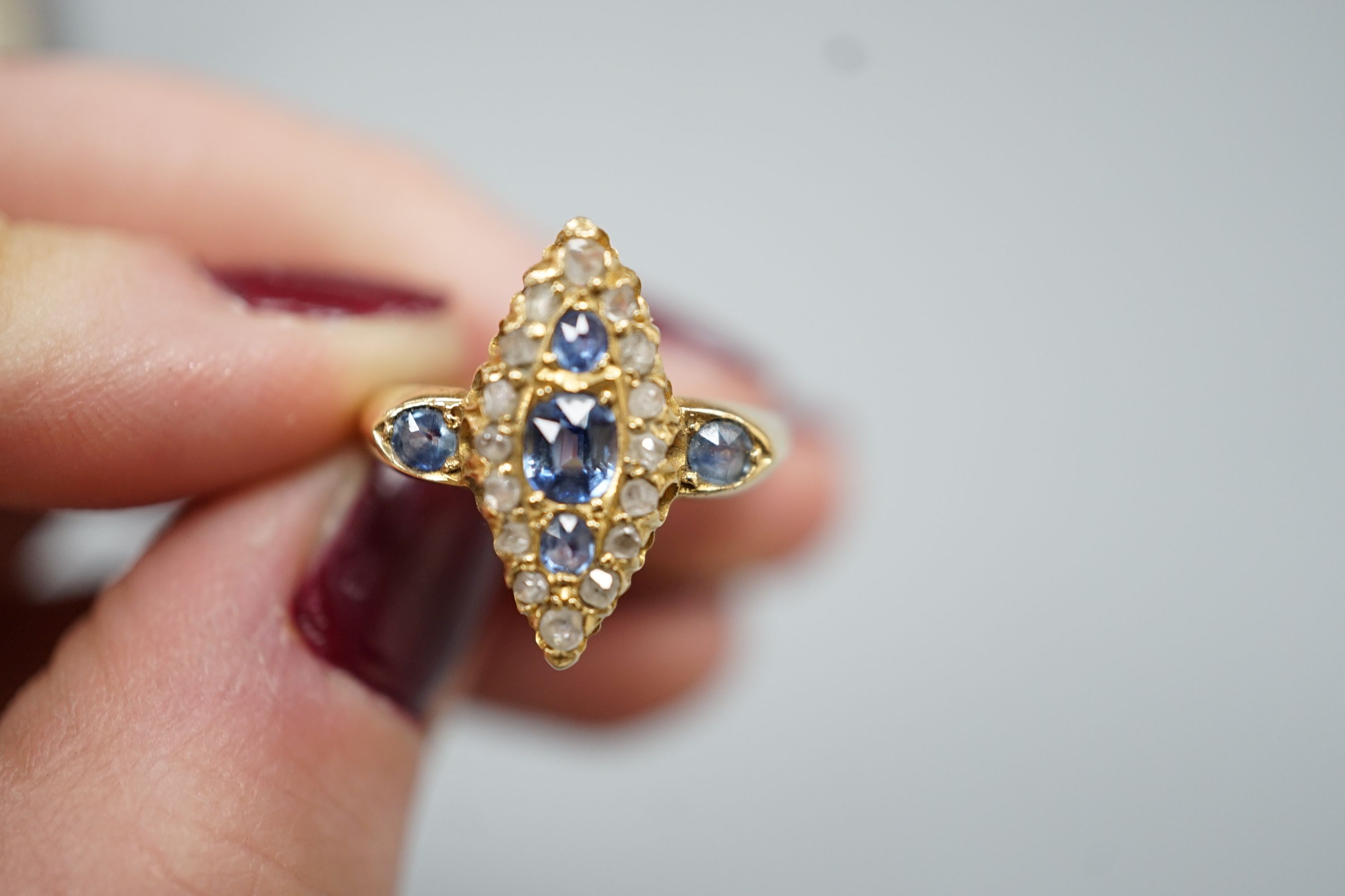 An Edwardian 18ct gold, sapphire and diamond set marquise set cluster ring, size K, gross weight 3.2 grams